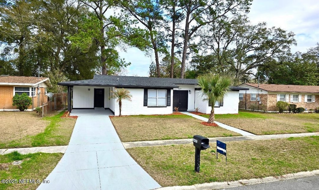 single story home with a front lawn and a carport