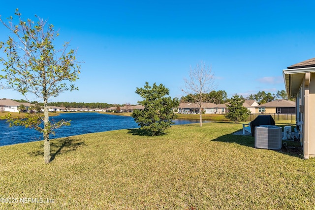 view of yard featuring a water view and central air condition unit