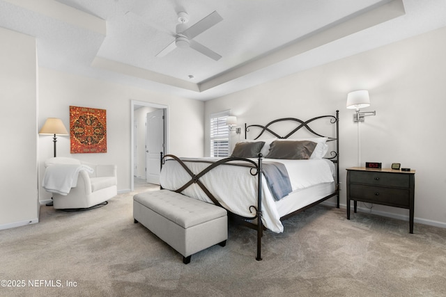 bedroom featuring carpet flooring, ceiling fan, and a raised ceiling