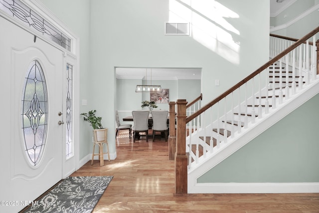 foyer entrance featuring hardwood / wood-style flooring and a chandelier