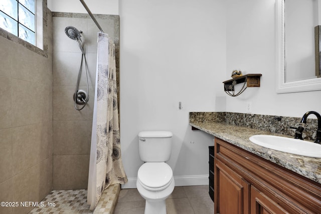 bathroom with tile patterned floors, vanity, toilet, and curtained shower