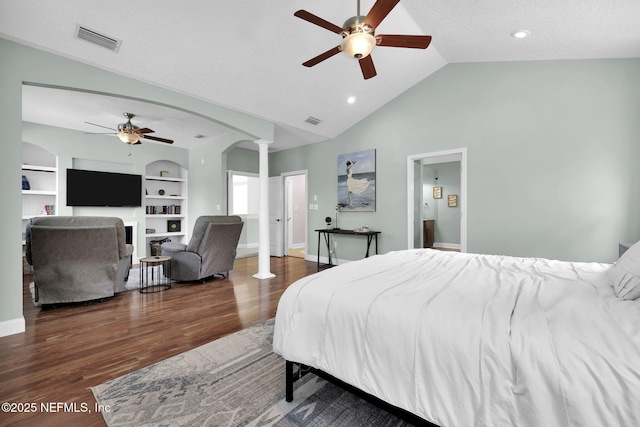 bedroom featuring lofted ceiling, dark hardwood / wood-style floors, ceiling fan, a textured ceiling, and decorative columns