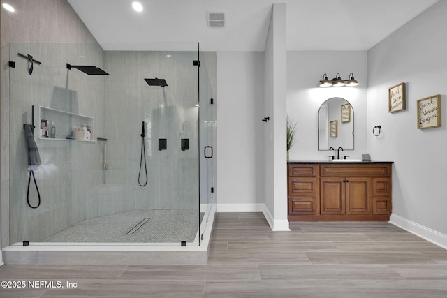 bathroom with vanity and an enclosed shower