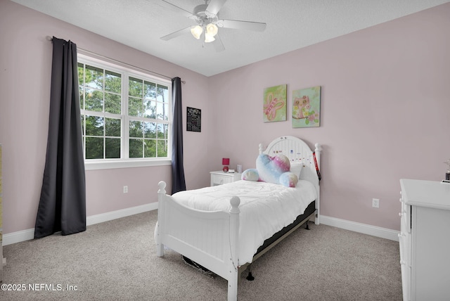 bedroom with ceiling fan, light colored carpet, and a textured ceiling