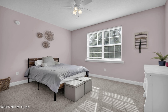 bedroom with ceiling fan and light colored carpet