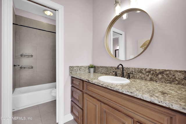 full bathroom featuring tile patterned floors, vanity, toilet, and tiled shower / bath combo