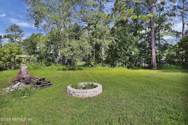 view of yard with a fire pit