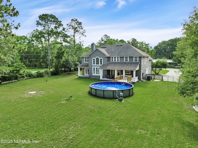 back of house featuring a lawn