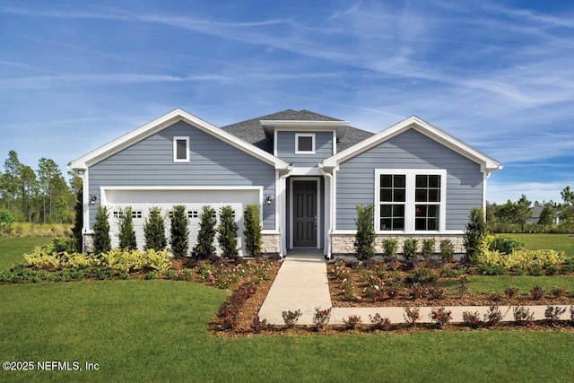 craftsman-style home with a front yard and a garage