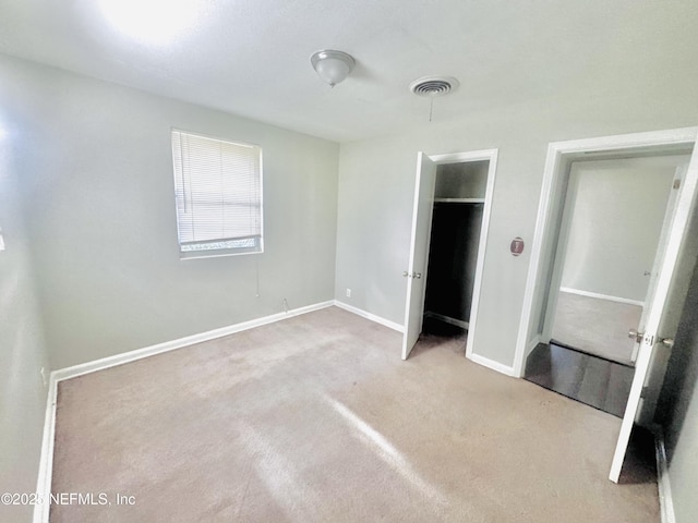 unfurnished bedroom with light colored carpet