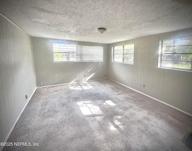 carpeted spare room featuring a textured ceiling