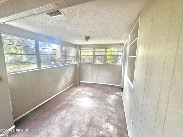 unfurnished sunroom featuring plenty of natural light