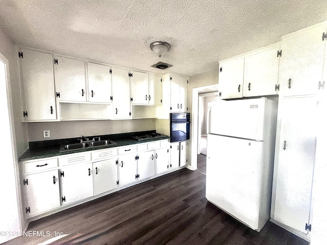 kitchen with white refrigerator, sink, black oven, dark hardwood / wood-style flooring, and white cabinetry