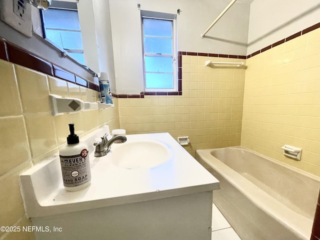 bathroom featuring vanity, shower / washtub combination, and tile walls