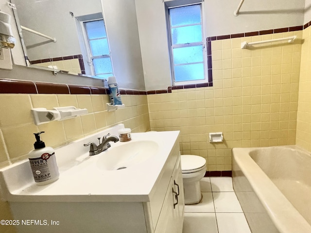 full bathroom with tile walls, vanity, toilet, tub / shower combination, and tile patterned floors