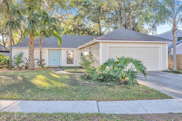 single story home with a garage and a front lawn