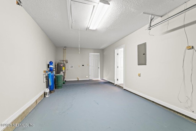 garage featuring electric panel and water heater