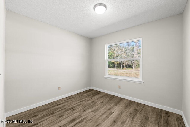 spare room with wood-type flooring and a textured ceiling