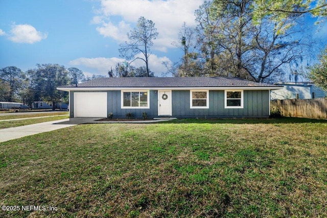 ranch-style home featuring a garage and a front lawn