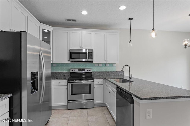 kitchen featuring pendant lighting, kitchen peninsula, sink, and stainless steel appliances