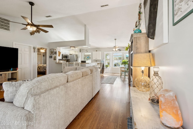 living room with ceiling fan, dark hardwood / wood-style flooring, and lofted ceiling