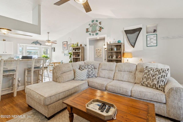 living room with vaulted ceiling and hardwood / wood-style flooring