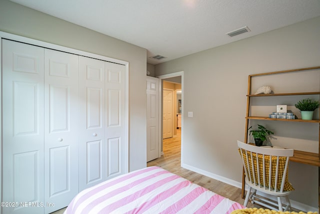 bedroom featuring a closet and light hardwood / wood-style floors