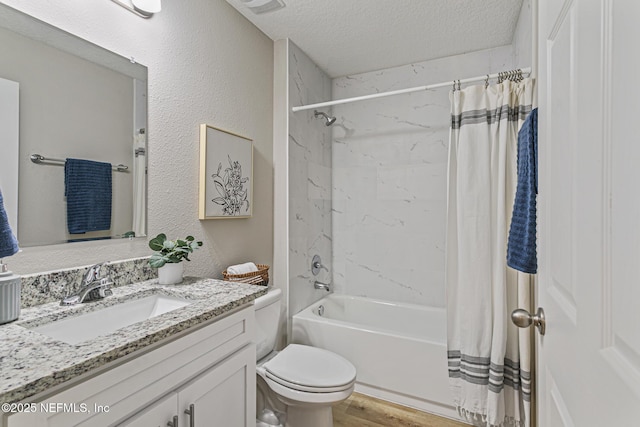 full bathroom with vanity, hardwood / wood-style flooring, toilet, a textured ceiling, and shower / tub combo