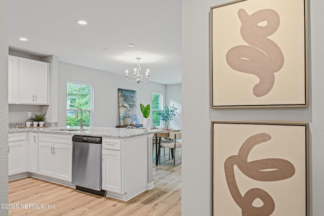 kitchen featuring dishwasher, white cabinetry, sink, and a wealth of natural light