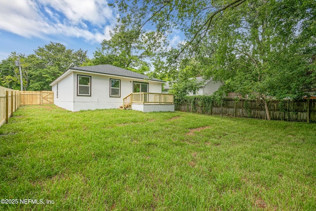 back of house with a yard and a wooden deck