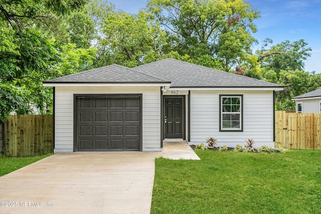 ranch-style home with a front yard and a garage