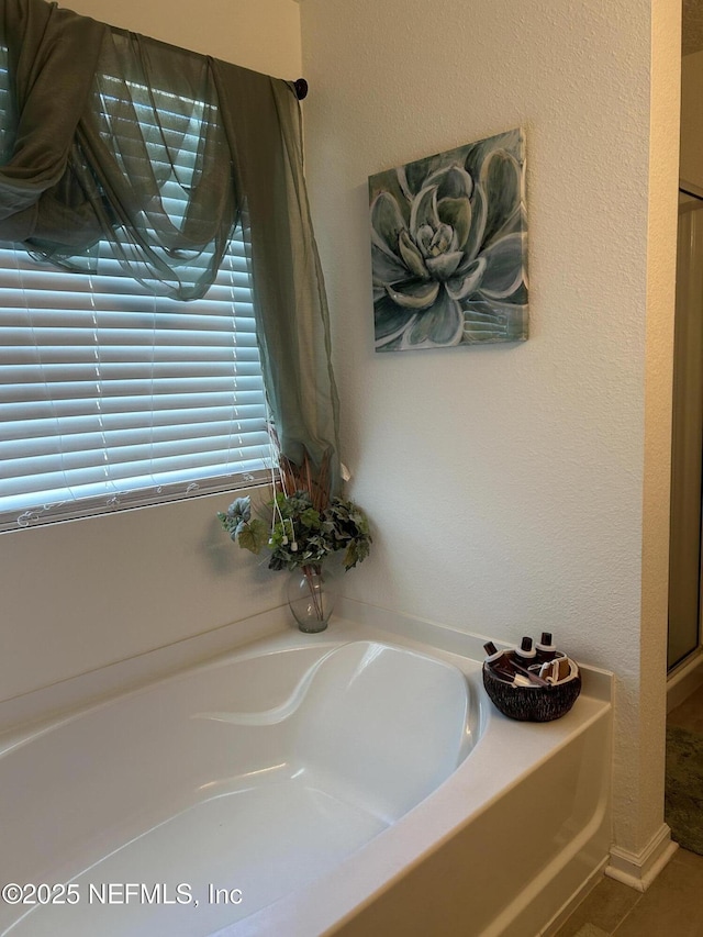 bathroom with a tub to relax in