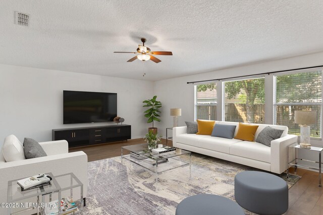 11786 Huckleberry Trl E, Macclenny, FL 32063 - living room with a textured ceiling, ceiling fan, and wood finished floors