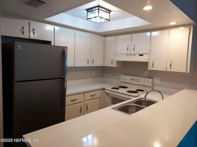 kitchen featuring refrigerator, white cabinetry, white electric stove, and sink