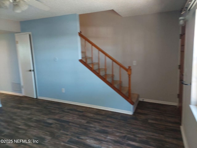 interior space featuring ceiling fan and dark wood-type flooring