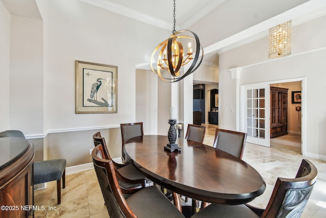 dining room with decorative columns, a chandelier, and ornamental molding