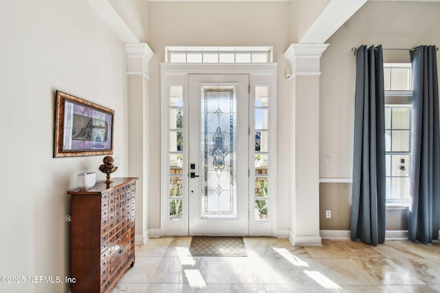 foyer entrance featuring decorative columns