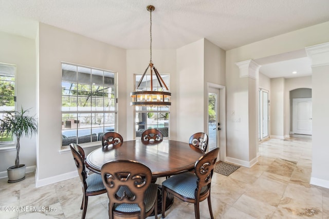 dining space with a textured ceiling