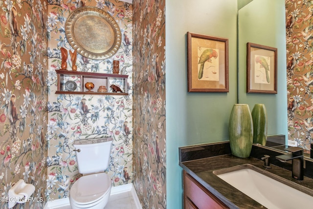 bathroom featuring tile patterned flooring, vanity, and toilet