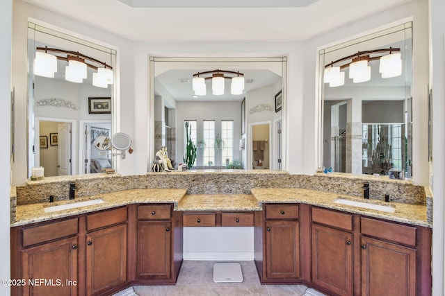 bathroom with vanity and a shower with door