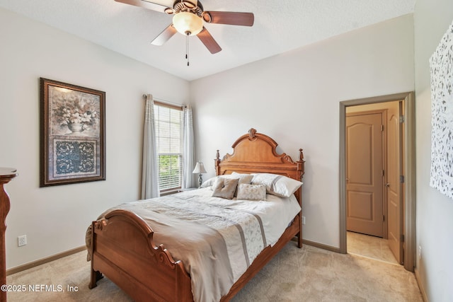 bedroom with ceiling fan and light colored carpet