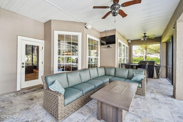 sunroom featuring ceiling fan