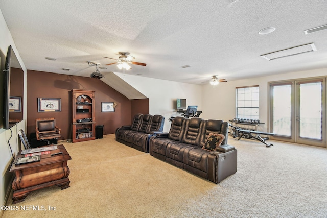 carpeted living room featuring ceiling fan and a textured ceiling