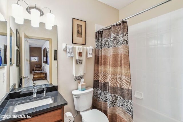 full bathroom featuring vanity, shower / tub combo, and toilet