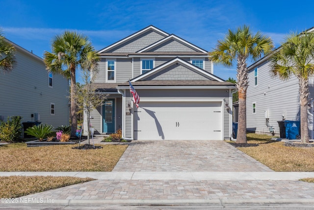 view of front of house with a garage and a front yard