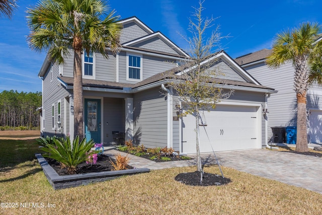 view of front of home featuring a garage and a front yard