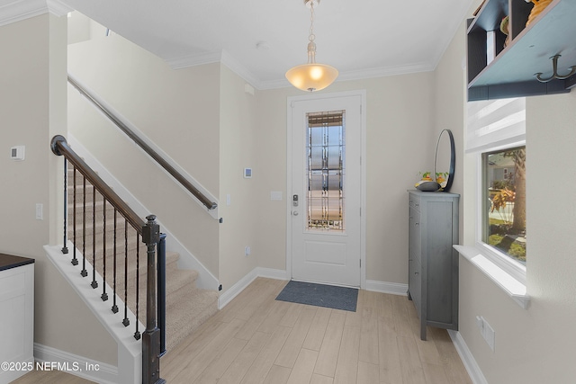 entrance foyer featuring crown molding and light hardwood / wood-style floors