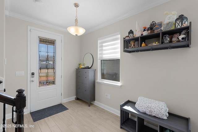 entrance foyer featuring ornamental molding and light hardwood / wood-style floors