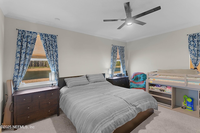 carpeted bedroom with crown molding and ceiling fan