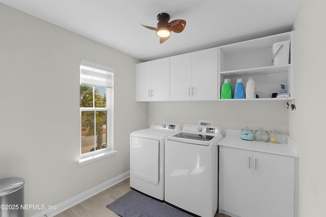 washroom featuring cabinets, ceiling fan, washer and clothes dryer, and light hardwood / wood-style flooring